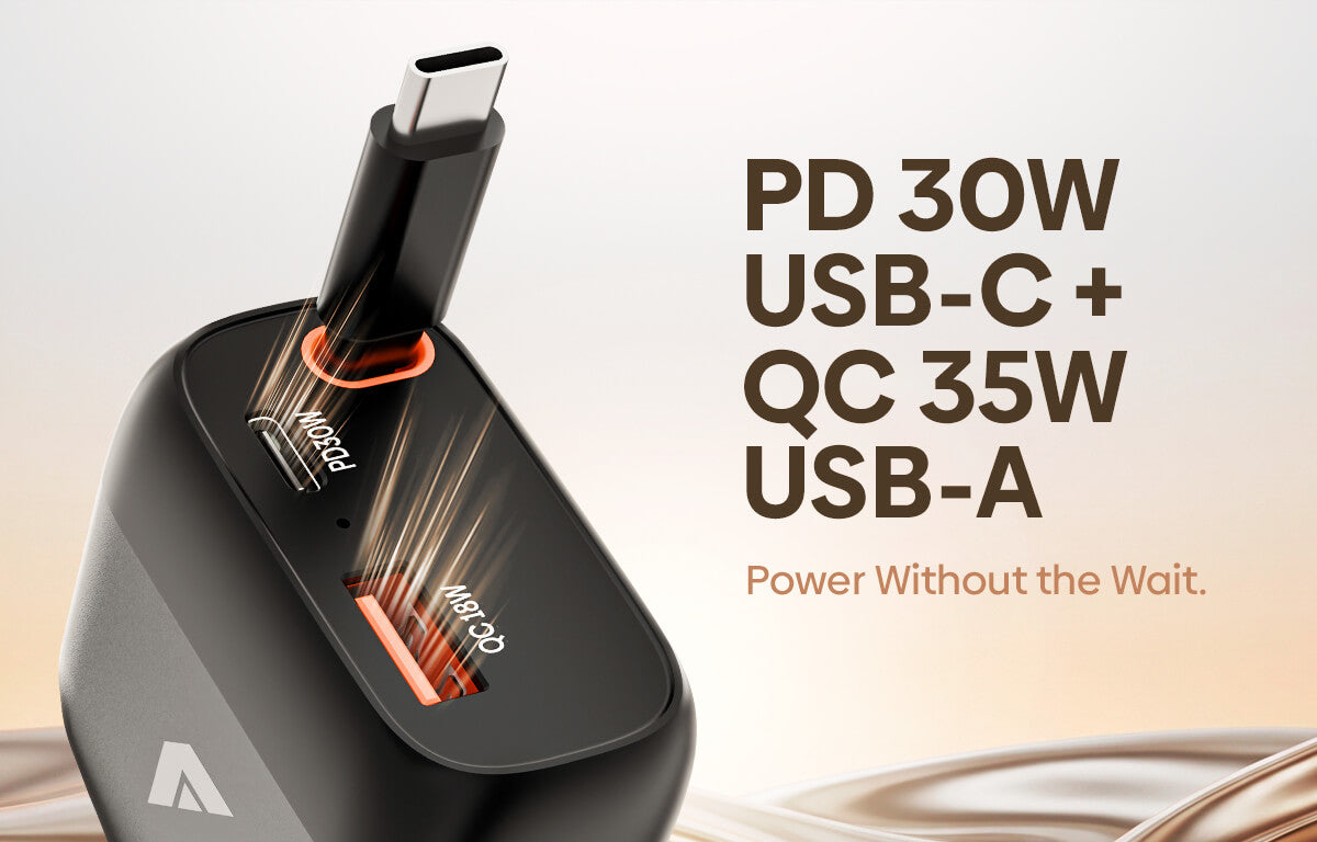 A black dual USB-C charging dock with a USB-C cable inserted, shown alongside marketing text reading 'PD 30W USB-C + QC 35W USB-A' and 'Power Without the Wait.' on a light beige background.