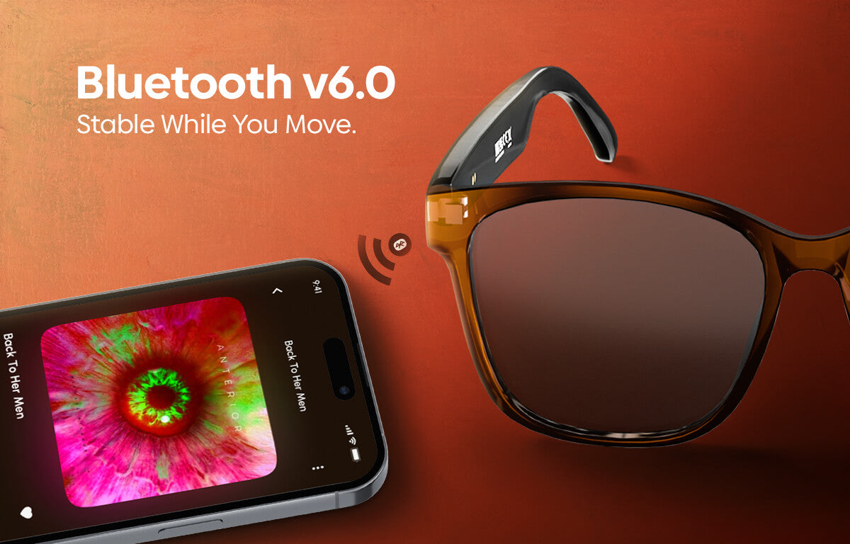 Smart sunglasses with a brown acetate frame and built-in Bluetooth receiver, shown next to a smartphone displaying a colorful screen on a warm orange background with 'Bluetooth v6.0 Stable While You Move.
