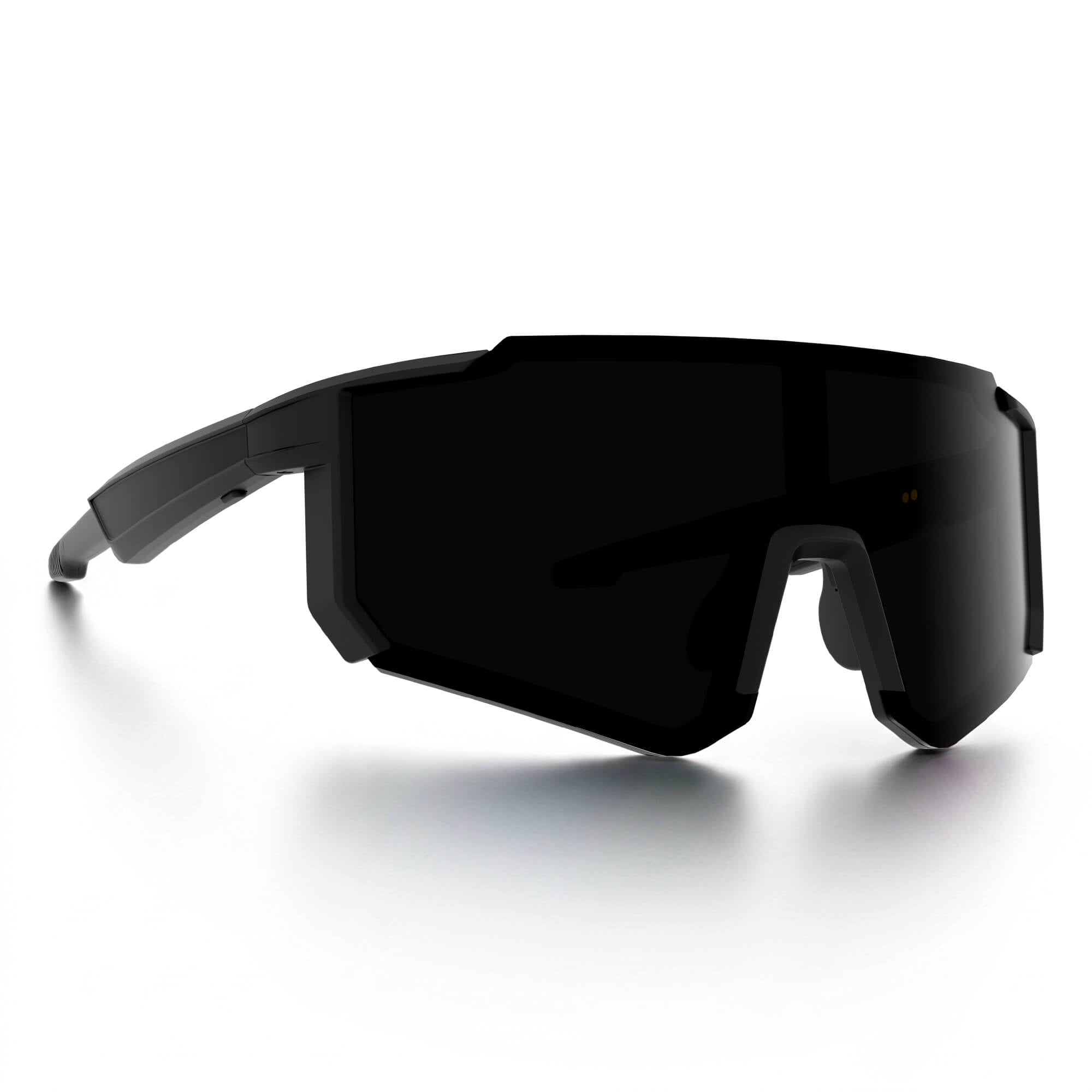 A pair of futuristic wraparound shield smart glasses with a matte black frame and dark tinted lenses, shown on a clean white background with a soft reflection.