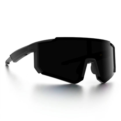 A pair of futuristic wraparound shield smart glasses with a matte black frame and dark tinted lenses, shown on a clean white background with a soft reflection.