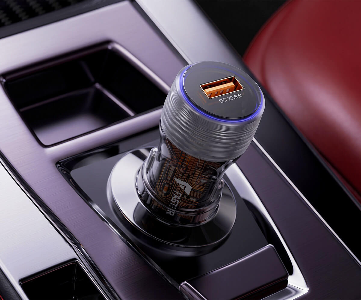A 2-Amp 5V USB car power adapter with a clear body showing internal circuitry, a metallic silver threaded cap, and a blue LED ring light, shown plugged into a car's center console.