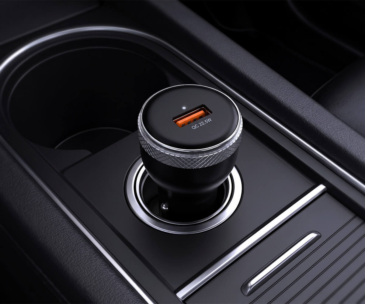 A black car dual USB charger with a textured silver ring, shown installed in a car console.