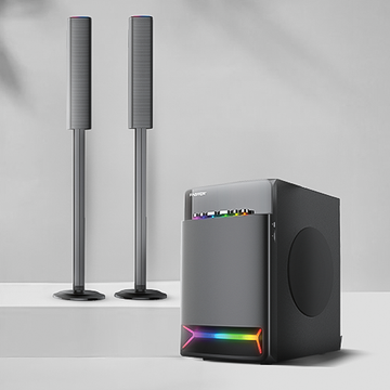 A soundbar with a subwoofer, primarily black in color, with a soundbar standing vertically and the subwoofer lying horizontally. Both are illuminated with a multicolored LED strip.