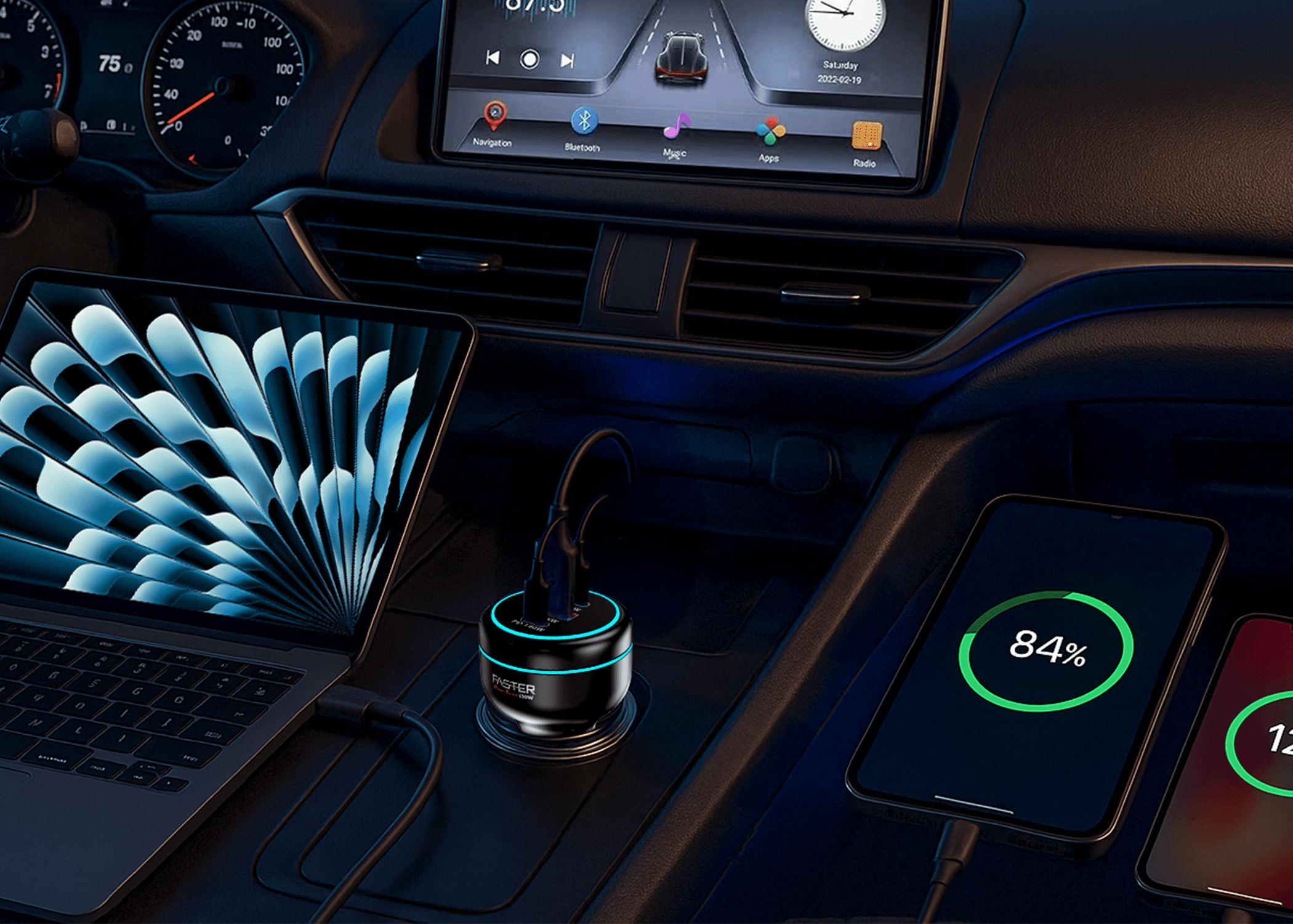 A car center console scene showing a small circular wireless charger with a glowing blue ring, connected to a laptop and a smartphone. The phone screen shows 84% battery, and the car interior is visible in the background.