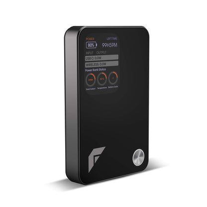 A black rectangular portable power bank with rounded corners, a digital status display on the front, three circular buttons, and a silver power button, shown on a white background.